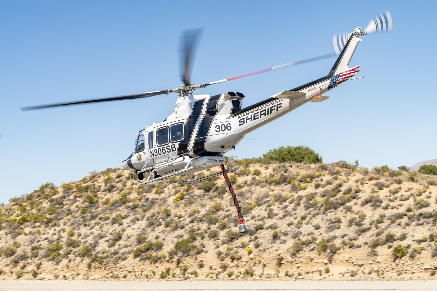 San Bernardino Sheriff's "Fire Attack" Bell 412 helicopter flies past me after picking up water in the California Aqueduct to put on a prescribed burn near Silverwood Lake. I hiked up a hill opposite the aqueduct so that I could be above or at eye level of most of the photographs I took.