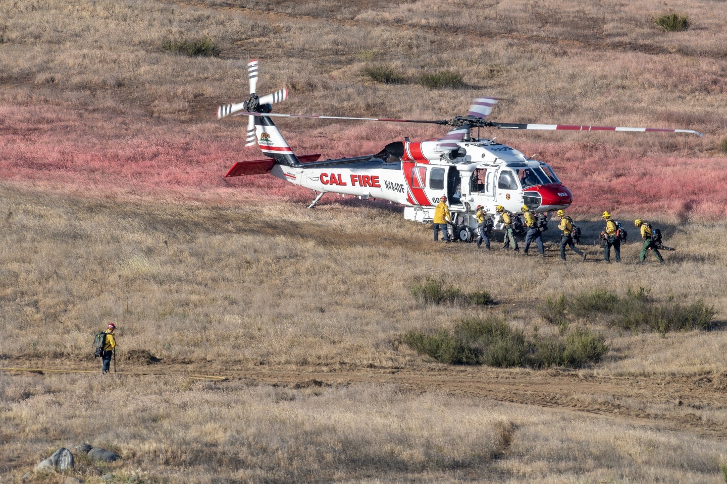 Cal Fire's Firehawk picks up its crew after fighting the Baxter Fire in Murrieta, California. I hiked into a hilly area to get the best angle while the fire was smothering around us.