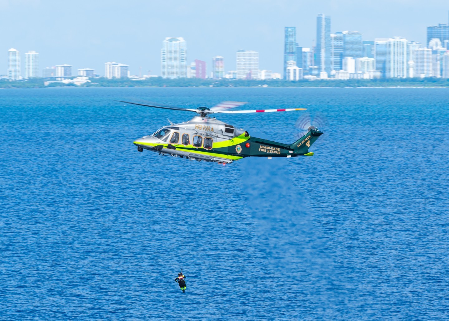 Miami Dade Fire Rescue's Air Rescue 4 is pictured here extracting a rescue diver from the  Miami Beach waters during training.