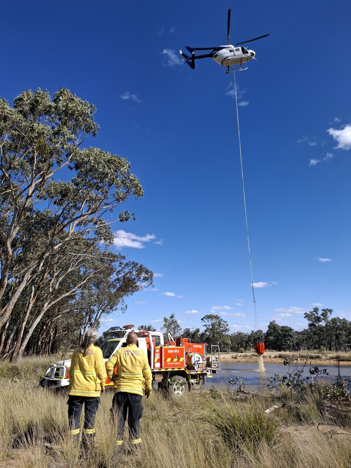 Bomber with longline bucket refilling from a dam at the Garling Trail fire near Dubbo NSW. Aircraft worked closely alongside ground crew in the suppression of this fire.
