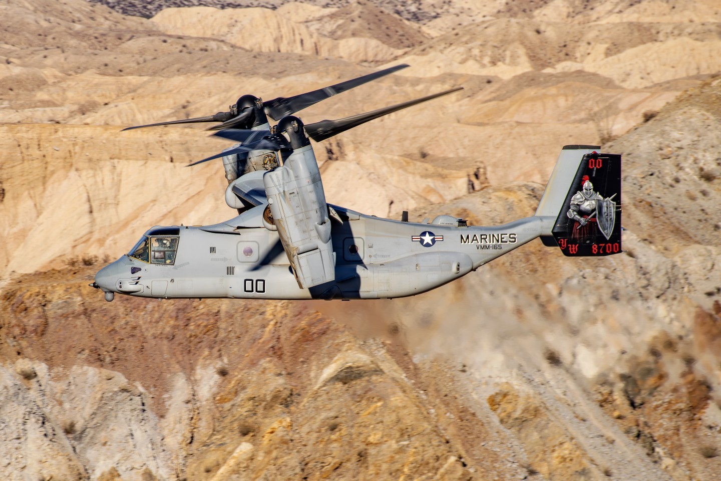 A photo shoot with VMM-165 White Knights newly painted color bird was set up in a remote canyon in Anza-Borrego Desert State Park. This photograph really highlights the beautiful design on the tail created and painted by Shayne Meder. Dave Nenna assisted her in the painting.