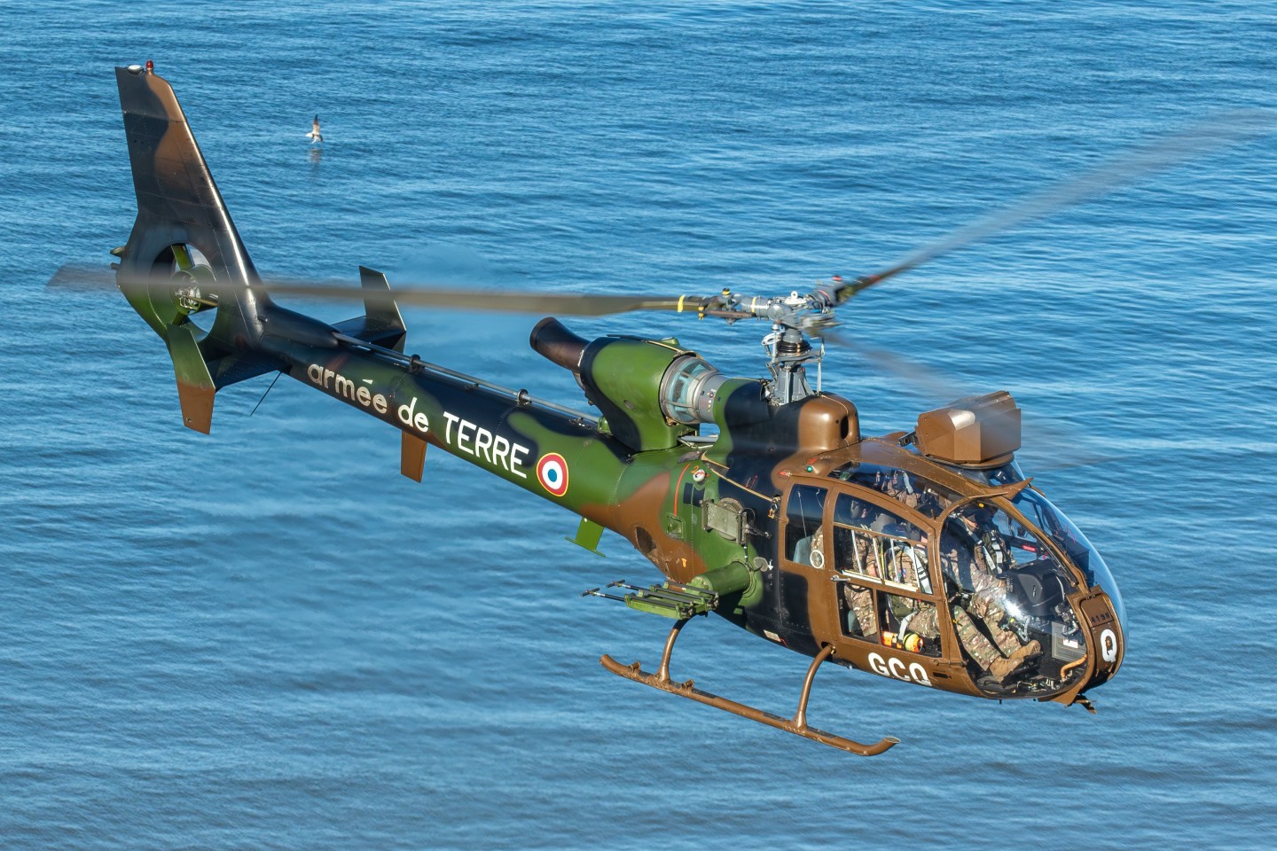 A French Armée de terre SA-342M Gazelle hovers above the canal. A unique photo setting to see these aircraft above the water, bringing special attention to the beautiful French color scheme.