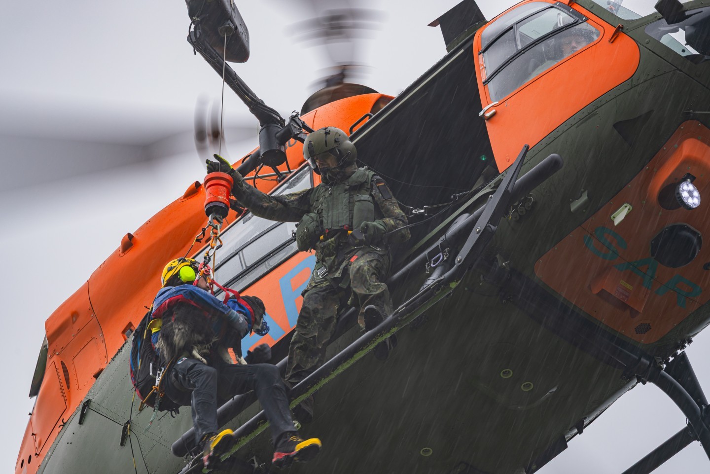 77+03, H145 LUH SAR of the Bundeswehr. The helicopter is based at Niederstetten Airfield. Here you can see it during a Training with the Rescuedogs of "Malteser Hilfsdienst" in bad weather conditions
