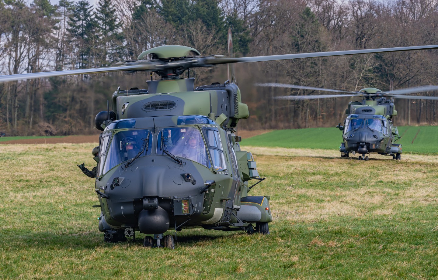 Nato Helicopter NH90 of the Bundeswehr during a training in Germany. The Helicopters are based at Niederstetten. It was a 4-Ship Formation. Here u can see 2 of the 4 Helicopters and two loadmasters waving