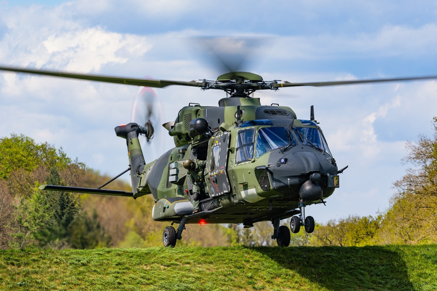 79+45 NH90 of the German Bundeswehr. The helicopter is based at Niederstetten Airfield. Here u can see it landing on a Dam. The loadmaster is checking the landing area