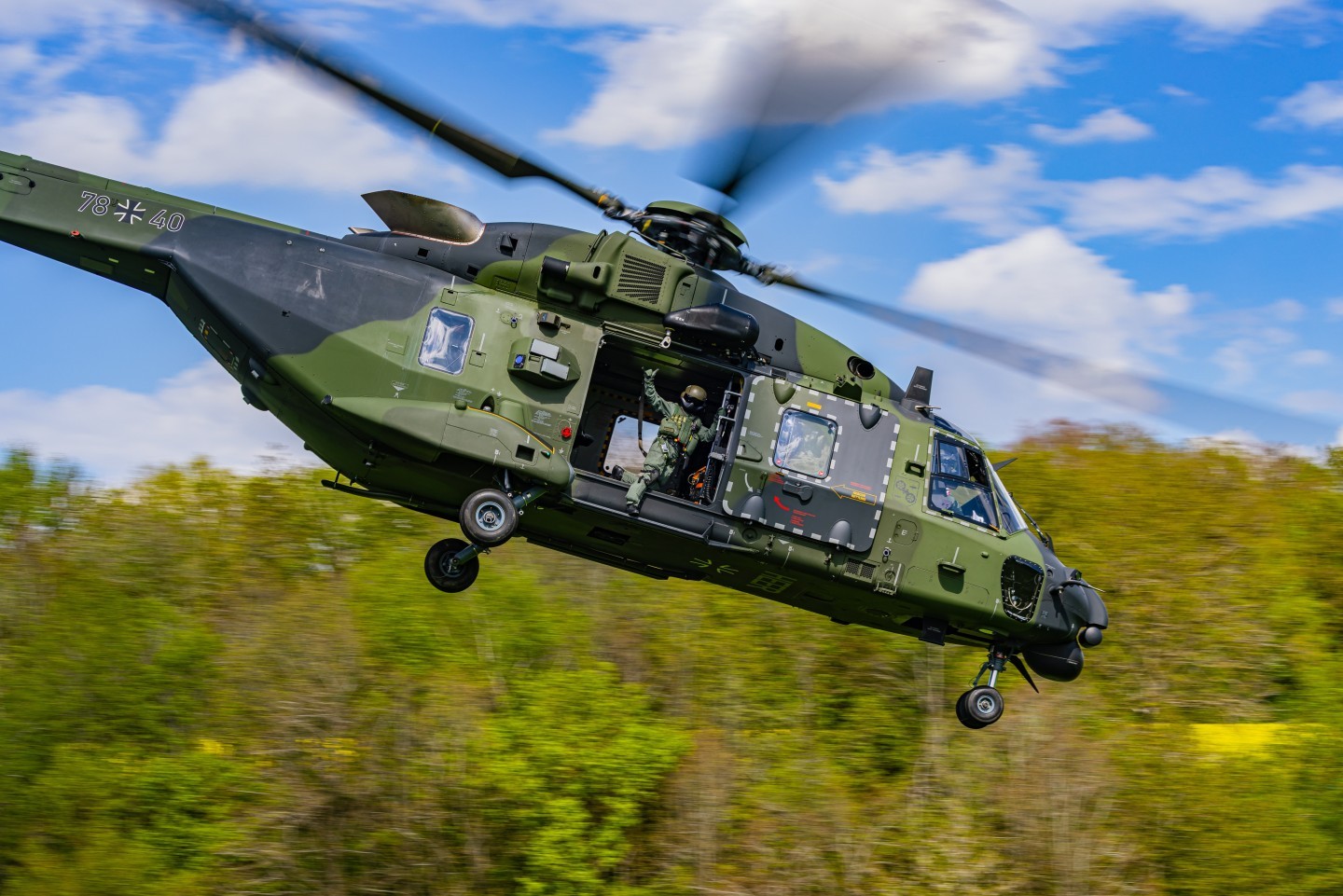 78+14 NH90 of the German Bundeswehr. The helicopter is based at Niederstetten Airfield. Here u can see it taking off after a Dam-Landing. The loadmaster is waving