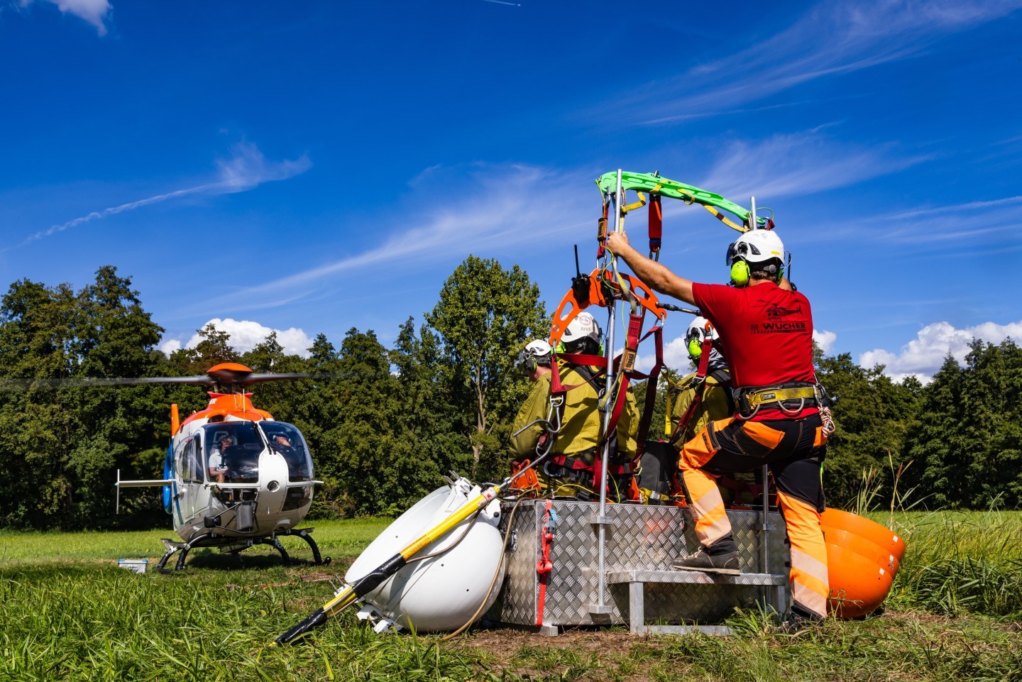 OE-XHZ Airbus EC135 helicopter of the austrian company Wucher. Here you can see the Helicopter taking off. They build a new Powerline. The chair is hanging under the Helicopter to bring the workers to the Powerline