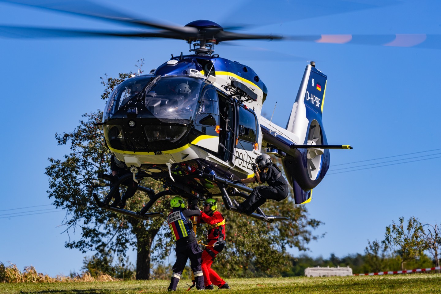 D-HPBF, Airbus H145D3 of the bavarian Police during an exercise of the Flughelfer Aschaffenburg. U can see them attaching slingload to the helicopter, while the technical crew member is sporty hanging on the skid