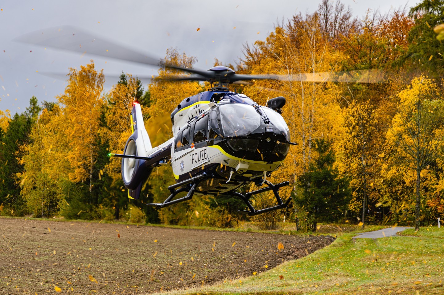 D-HPBF, Airbus H145D3 of the bavarian Police during an exercise of the Bergwacht Bayern. U can see the heliopter landing on a litte grass strip in beautiful autumn light