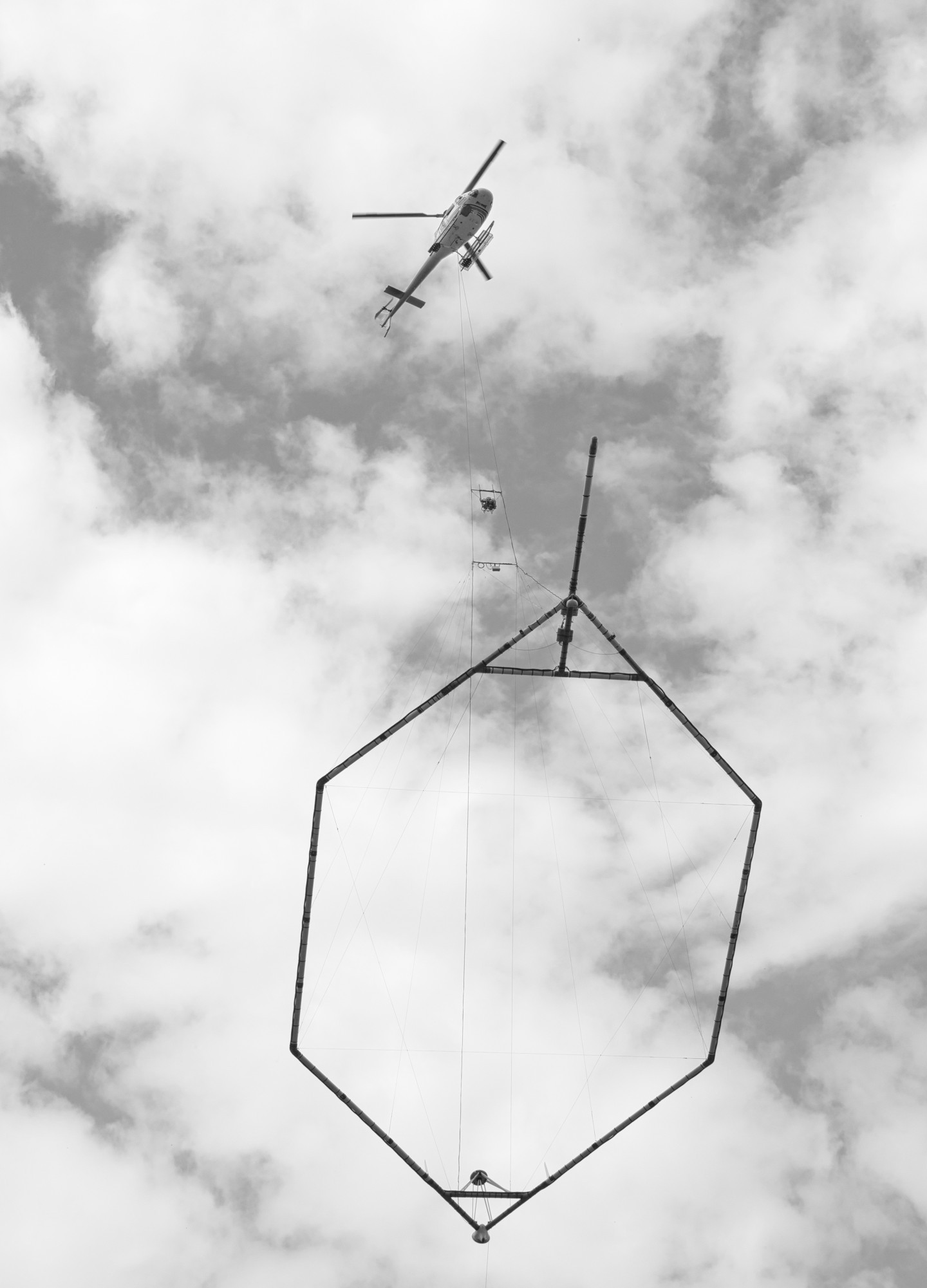 An AS350 B3 helicopter with Heli-Worx Aviation doing airborne geophysical surveying with SkyTEM Surveys.