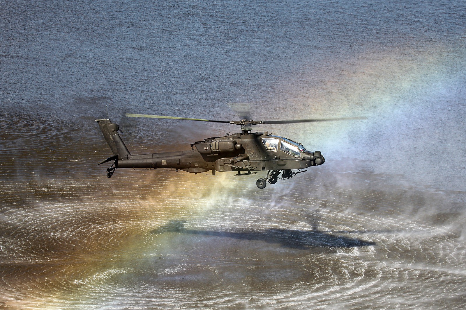 Leased US Army Apache with Polish emblems hoovering over Vistula River