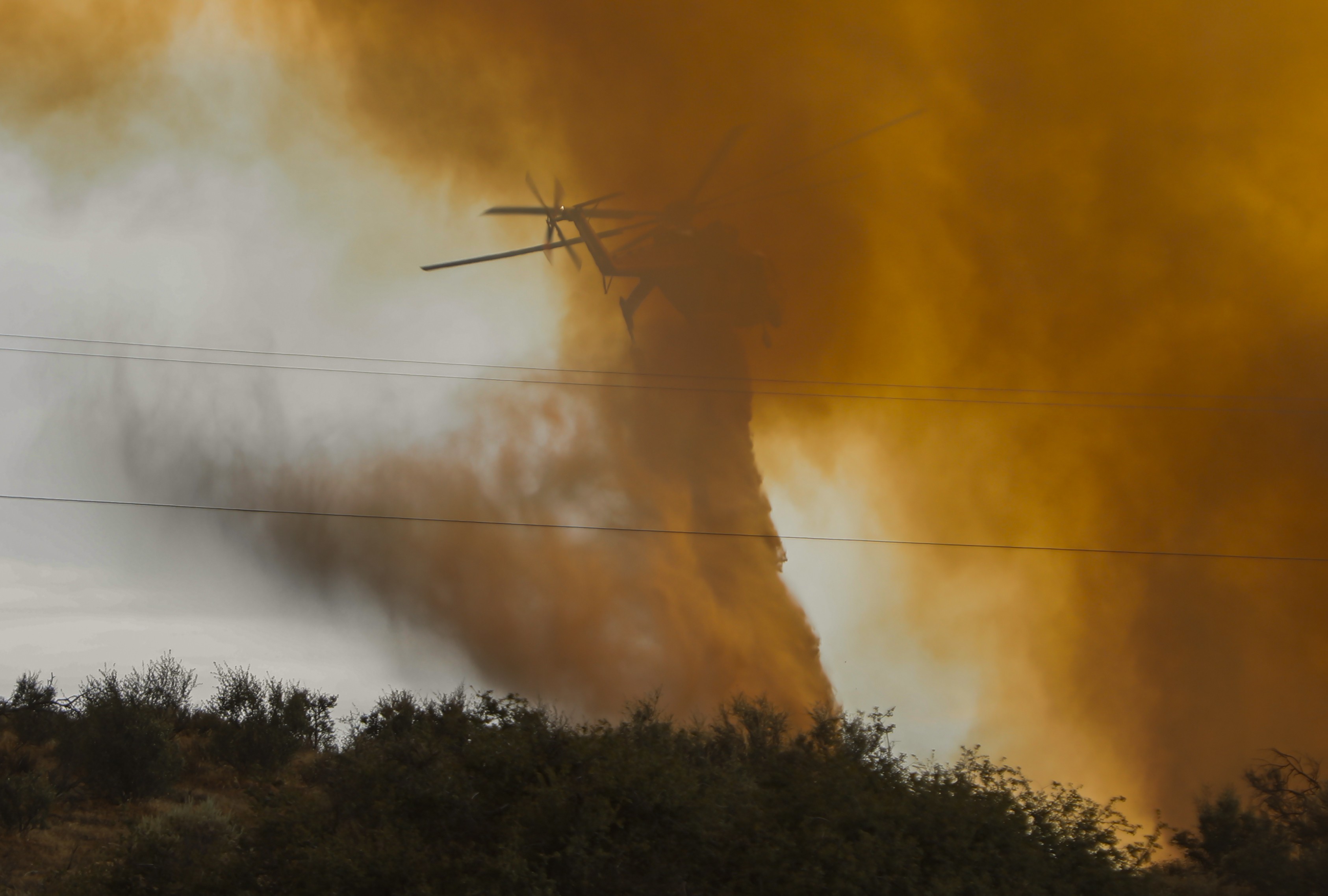 Helicopter Transport Services (Canada based operator) Helitanker 5HT, dousing flames part of a few hot spots in Riverside County, CA during the Dale Fire, Summer 2025.