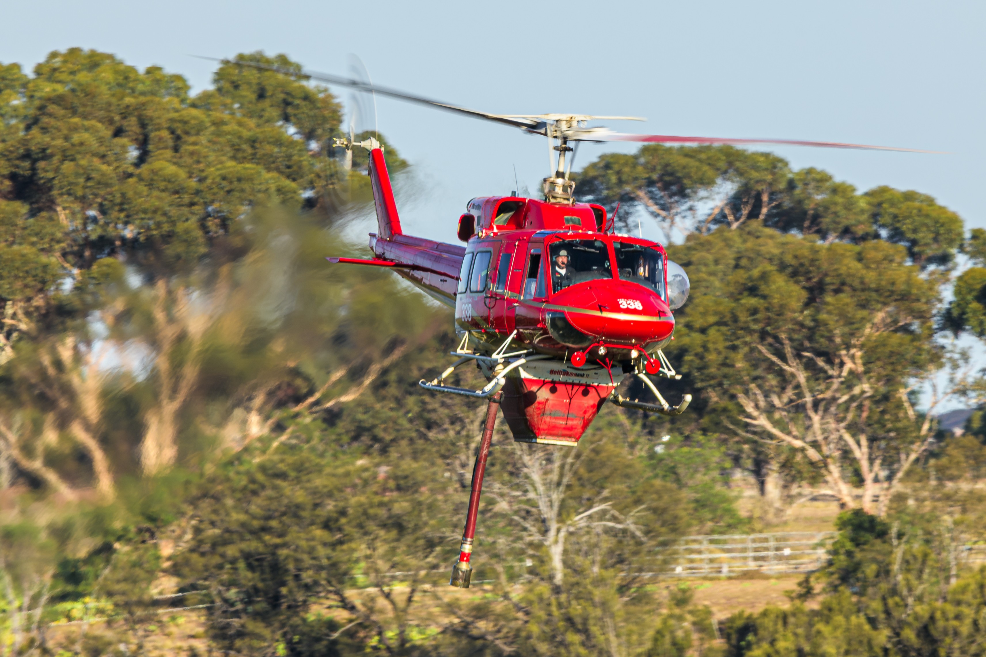 Microflite Bell 212 VH-JJR as 'HELITAK 338' emerges from a 100 metre deep gorge of the Werribee River during operations at a grassfire at Hopetoun Park.