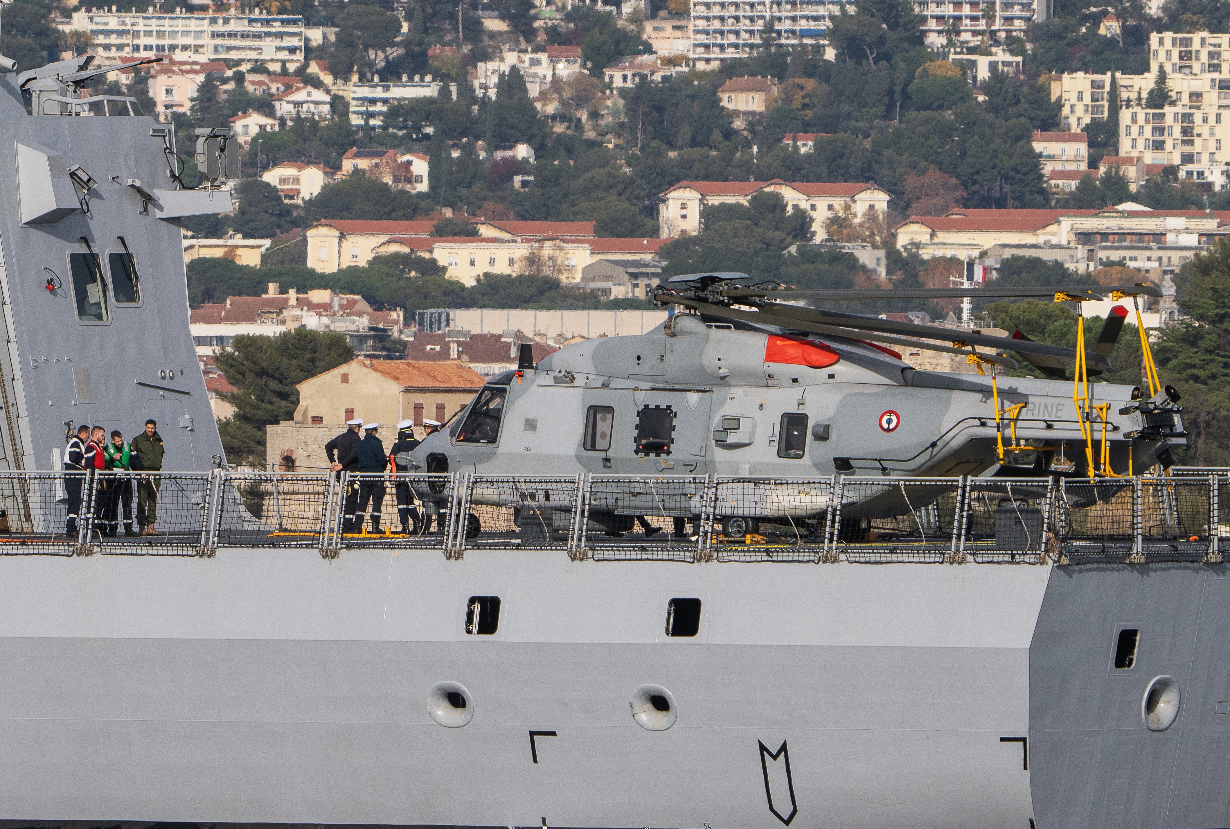 An NH90 helicopter and its crew on the deck of the frigate Amiral Ronarc'h (french navy)