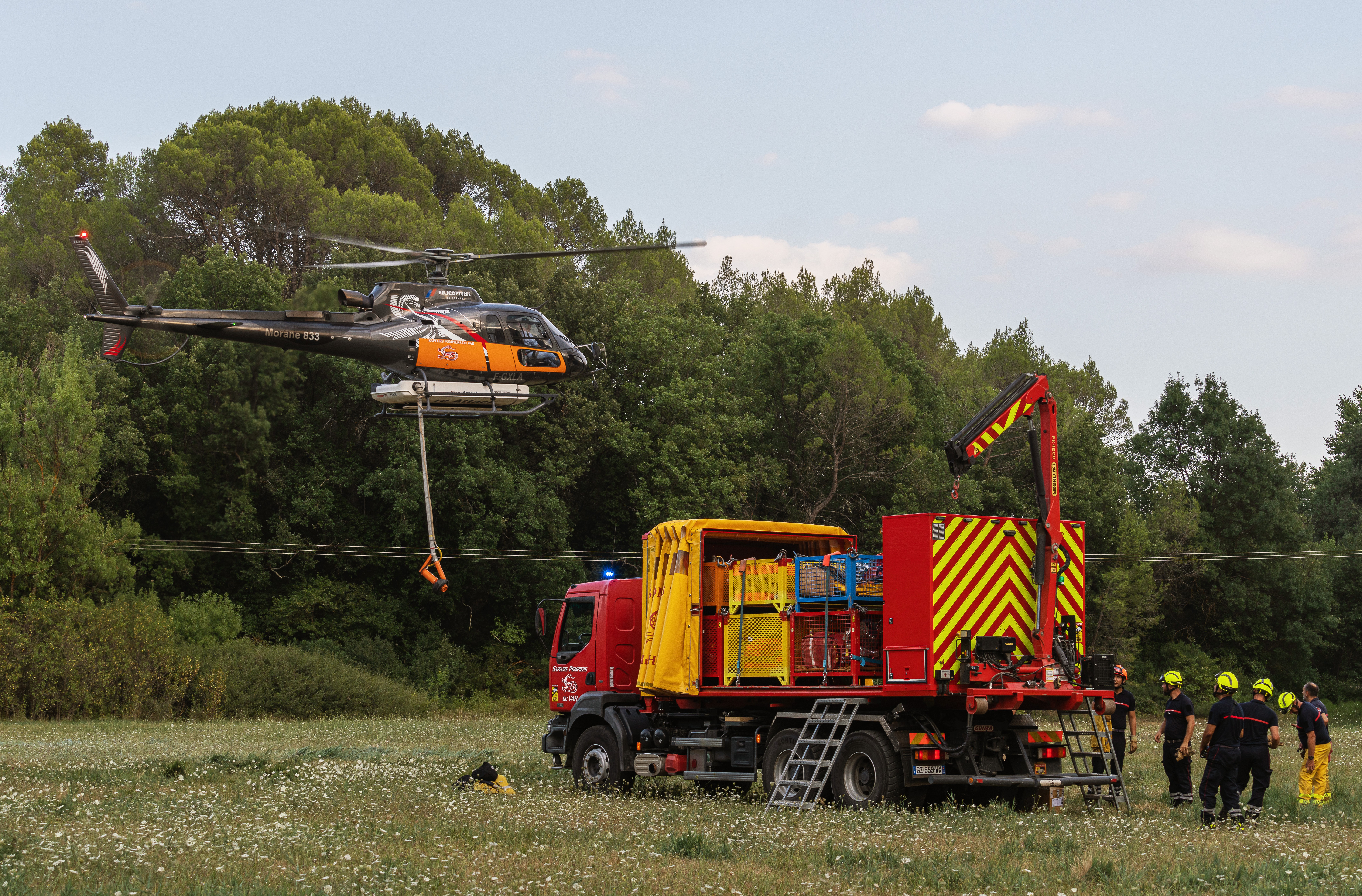 The Ecureuil helicopter and the equipment to be airlifted onto the truck for the fire in Pontevès (Var department), near the security command post, in France.
