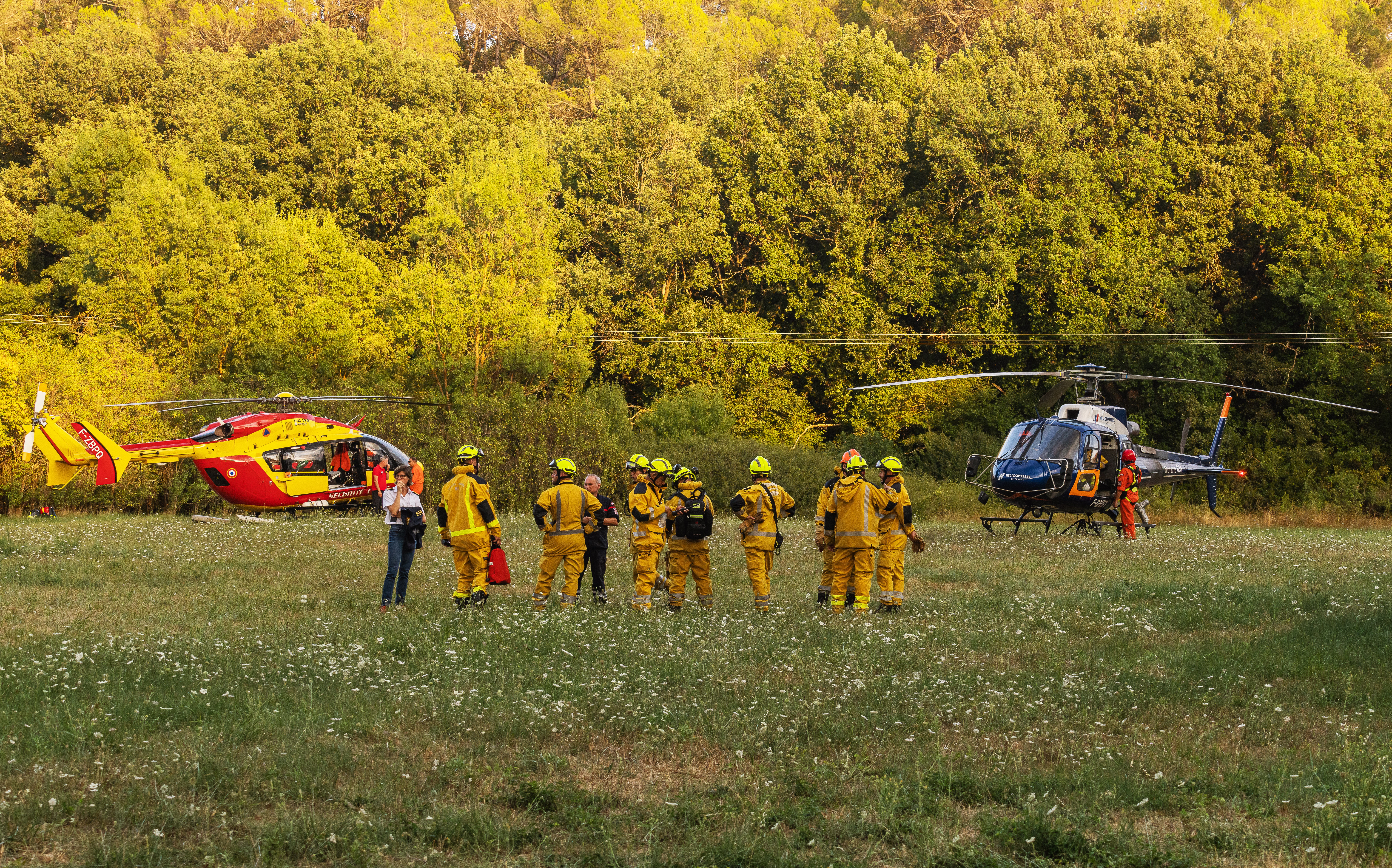 Ecureuil and Dragon helicopters are deployed to fight the fire in Pontevès (Var department), near the security command post, in France. Pictured are firefighters with the director of SDIS 83 and the sub-prefect of Brignoles.