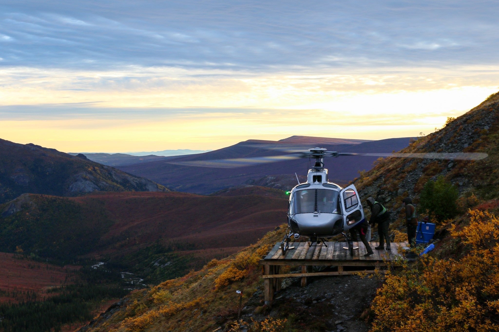 Drillers loading up early morning for shift change off the drill site. Somewhere in the eastern Alaska Range mountains with the beautiful September foliage setting the backdrop.