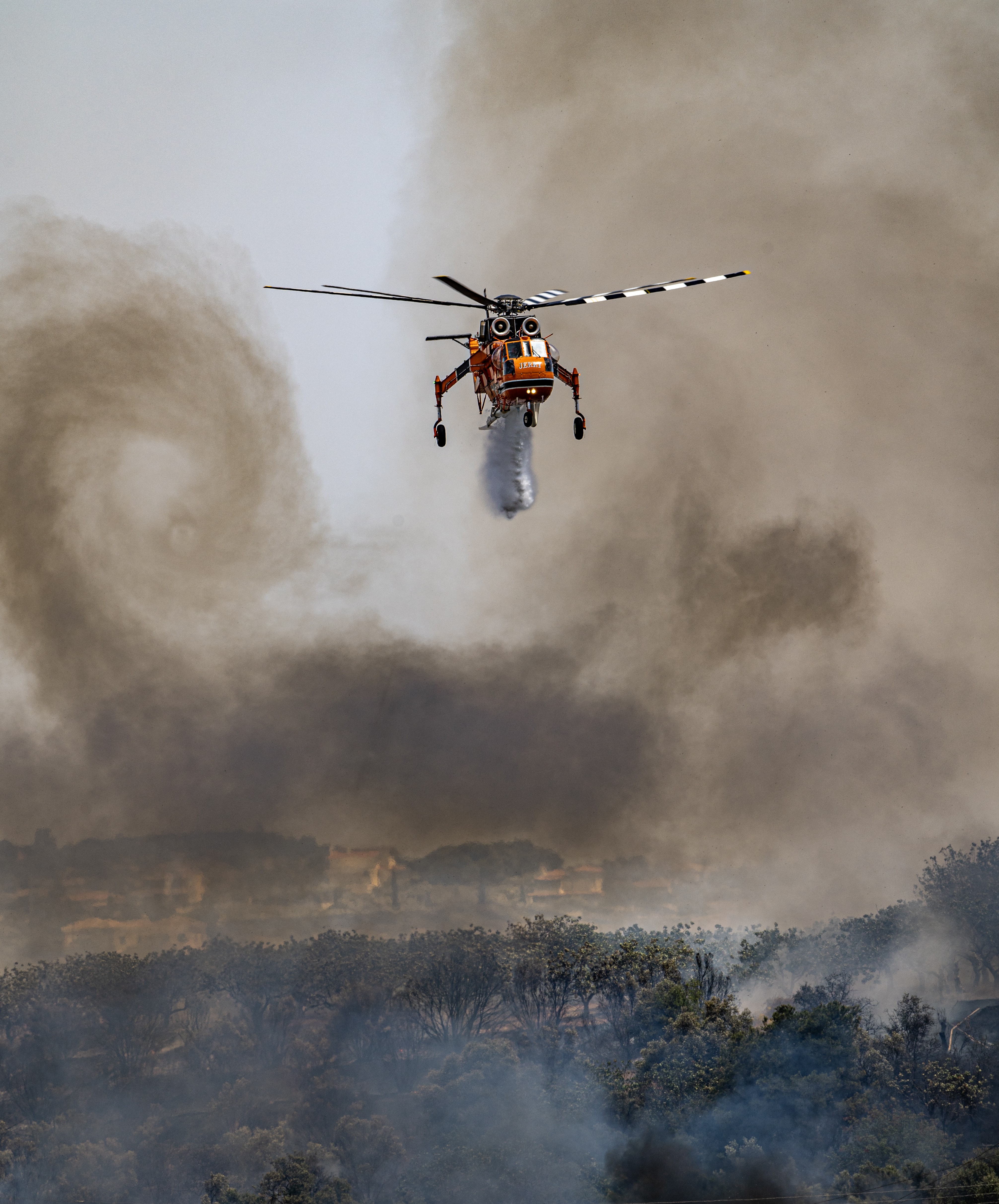 HELICOPTER EXPRESS S64 N-247AC BEGINNING WATER "BOMBING" ON A FIRE TO OLIVES TREES,  , NEAR   ATHENS AIRPORT WITH SOME  INTERESTING  FORMATION ON THE SMOKE