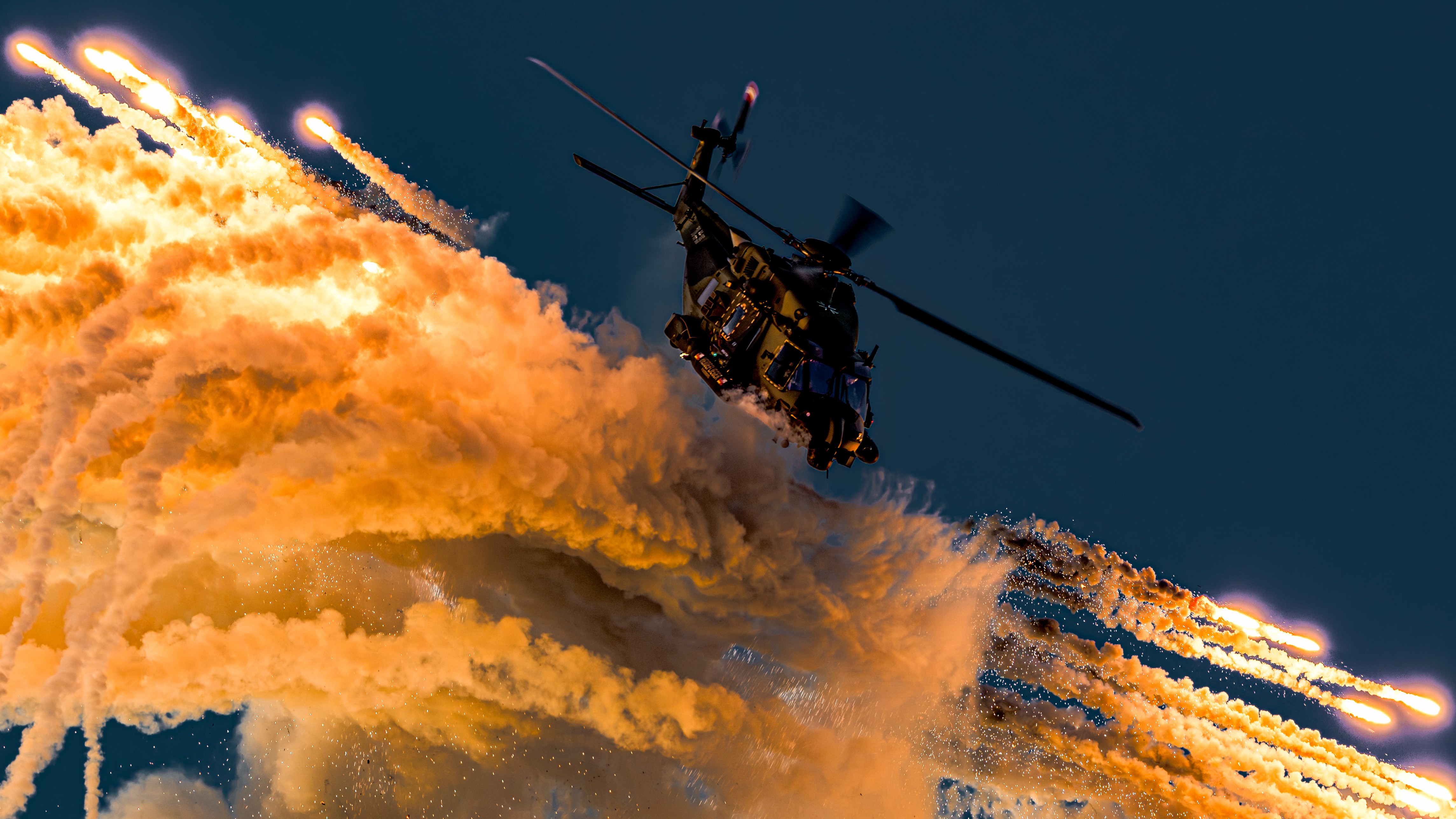GERMAN NH-90 PERFORMING A FLARE JETTISON DURING ANTIDOTUM AIRSHOW AT LESZNO, Poland, ON A SUNSET DISPLAY. THE PHOTO WAS TAKEN YUST BEFORE A DIVE MANOEUVRE.