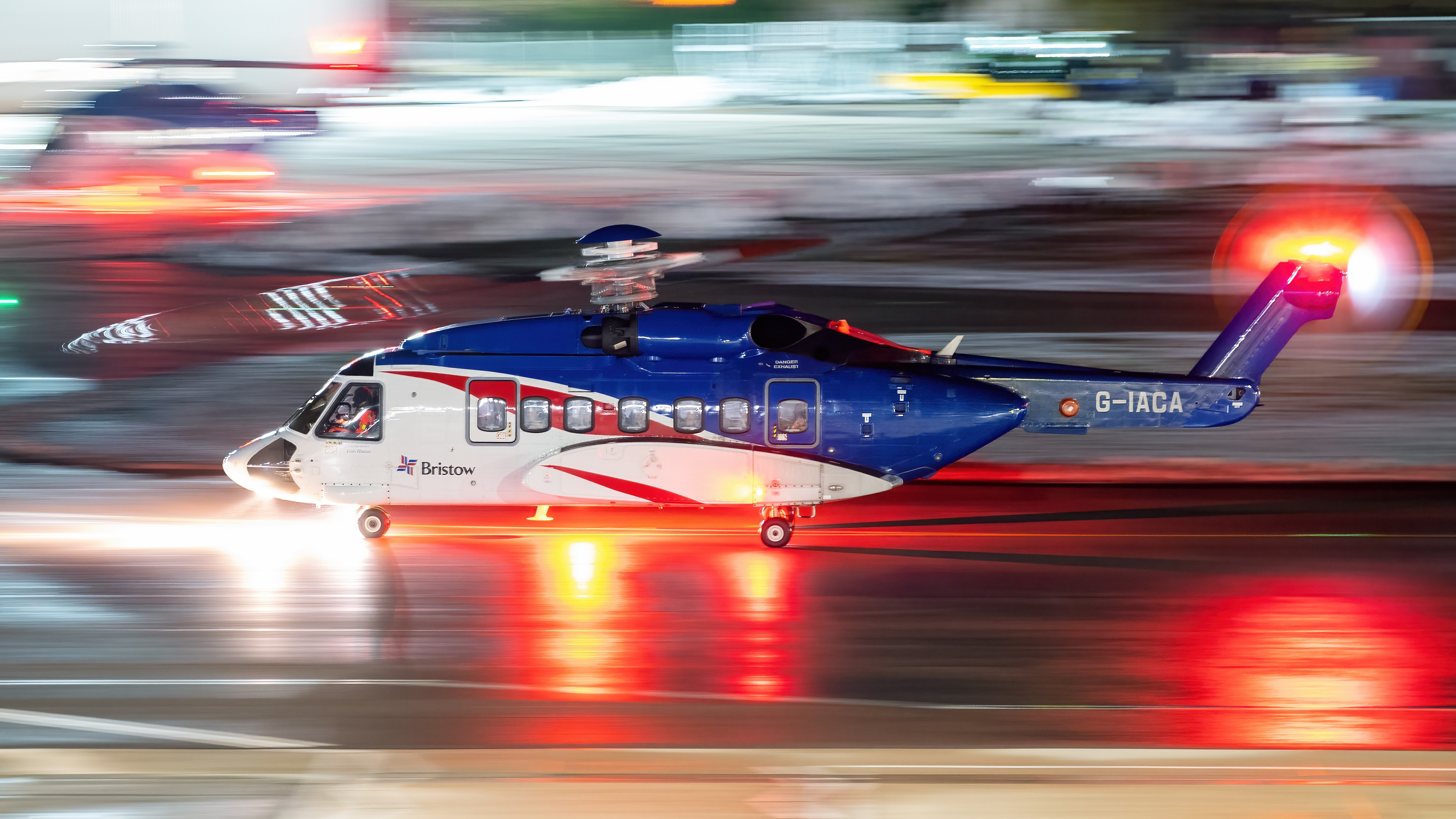 A Sikorsky S92 returns from offshore at night to a snowy ramp providing a great opportunity for reflections and light trails.