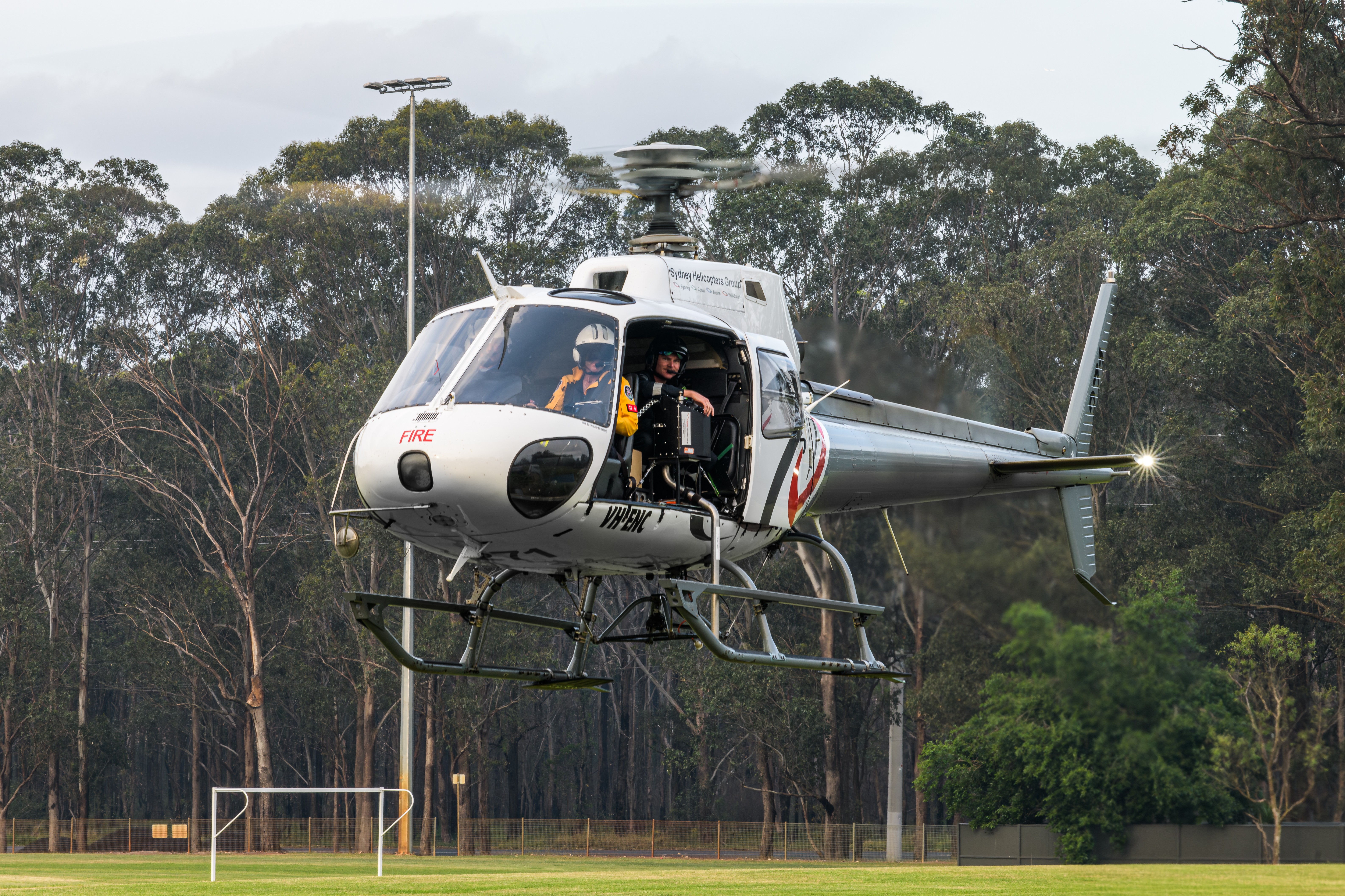 Sydney Helicopters Group AS350 VH-ENC as FIREBIRD271 landing at Wilberforce Woodlands Oval to refuel after conducting aerial ignition operations in support of hazard reduction burns.