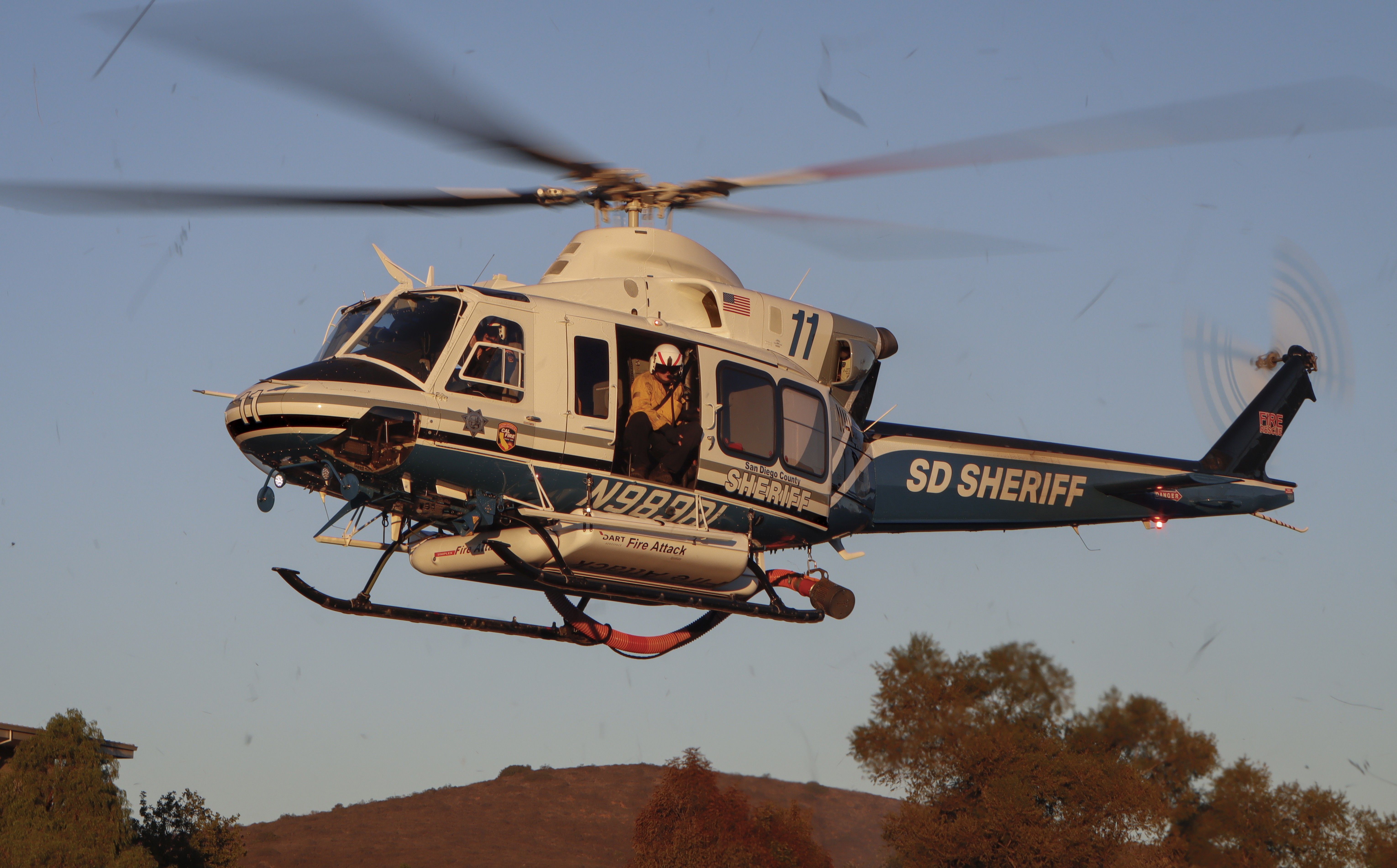 Copter 11 from the San Diego County Sheriff's Dept. departing the 4S Ranch area of San Diego, CA  after picking up their helitack crew during the Ranch Fire in October 2025.