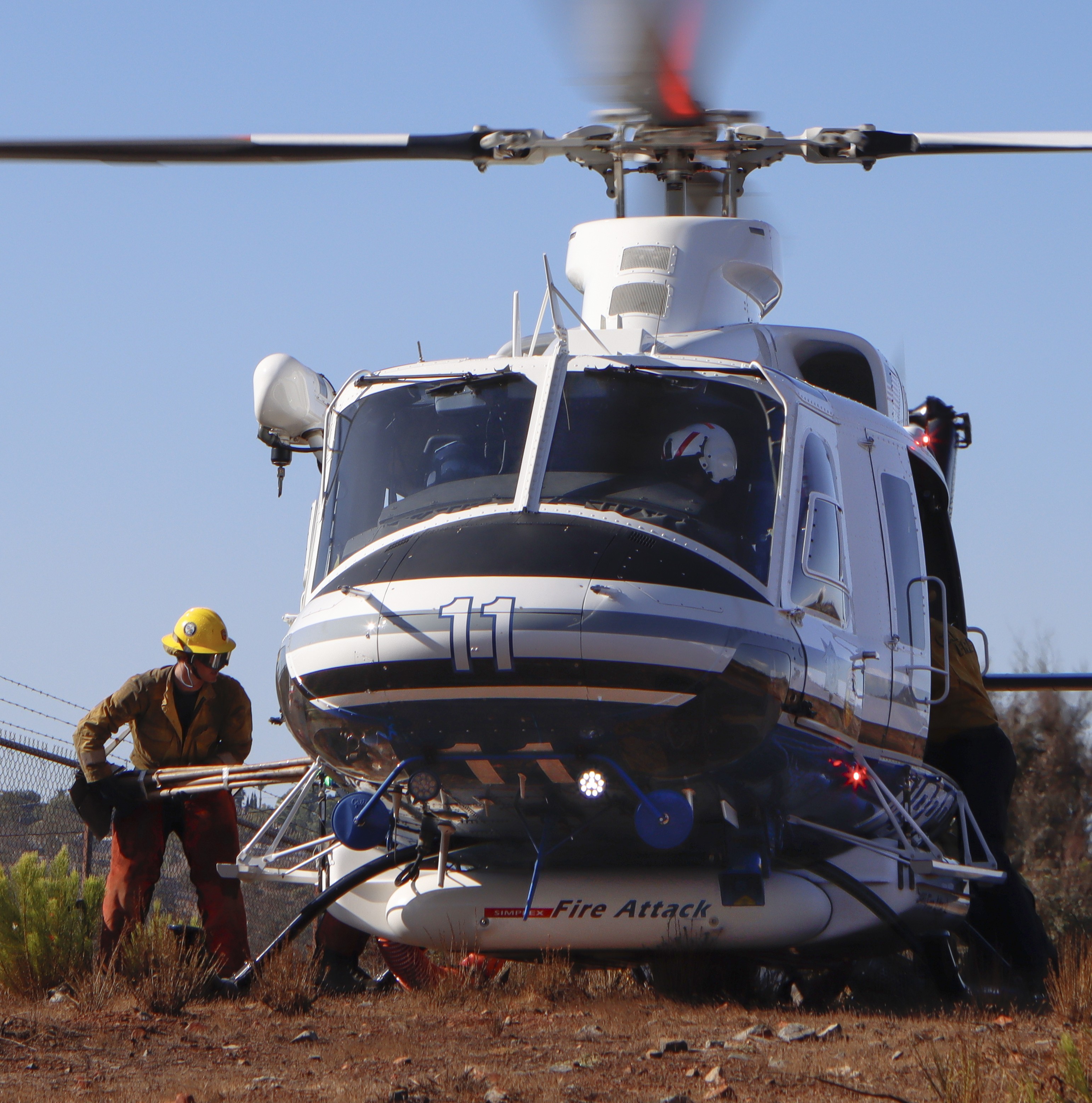 CAL FIRE helitack crewmembers assigned to Copter 11 of the San Diego County Sheriff's Dept. loading up the copter at the small LZ following the Lodge Fire in Jamul, CA.