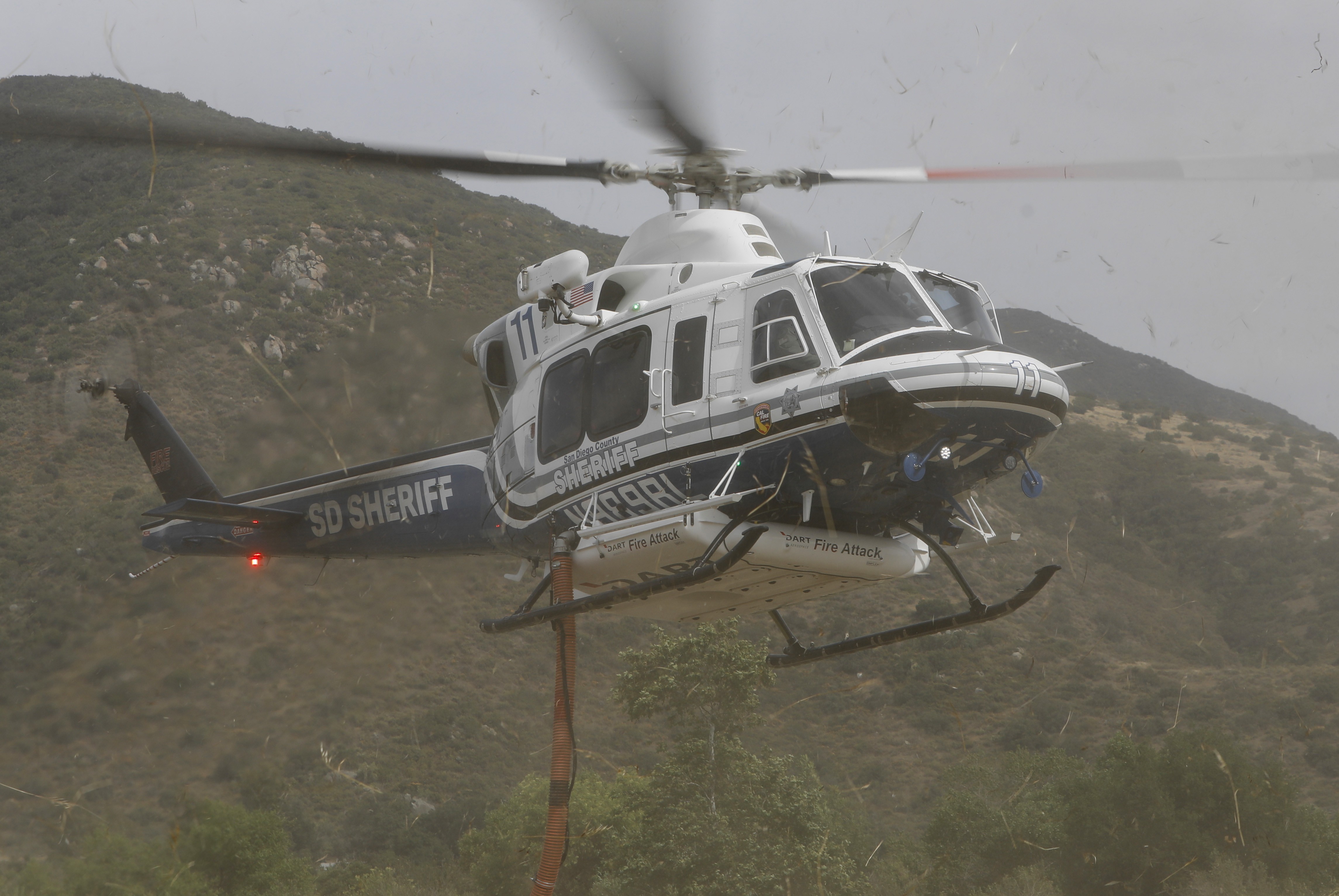 Copter 11 from the San Diego County Sheriff's Dept. returning to the temporary helibase on a fuel stop, during the Henderson Fire in Pala, CA of San Diego County.