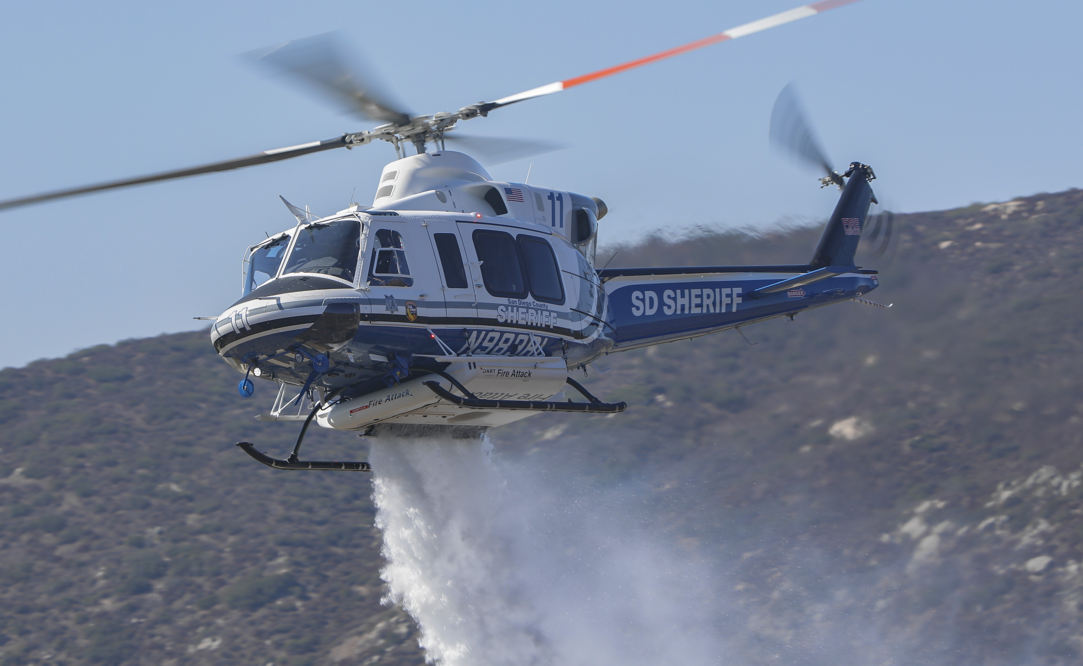 Copter 11 from the San Diego County Sheriff's Dept. dropping water part of a media demonstration of the use of a heli-hydrant for firefighting operations in San Diego County.