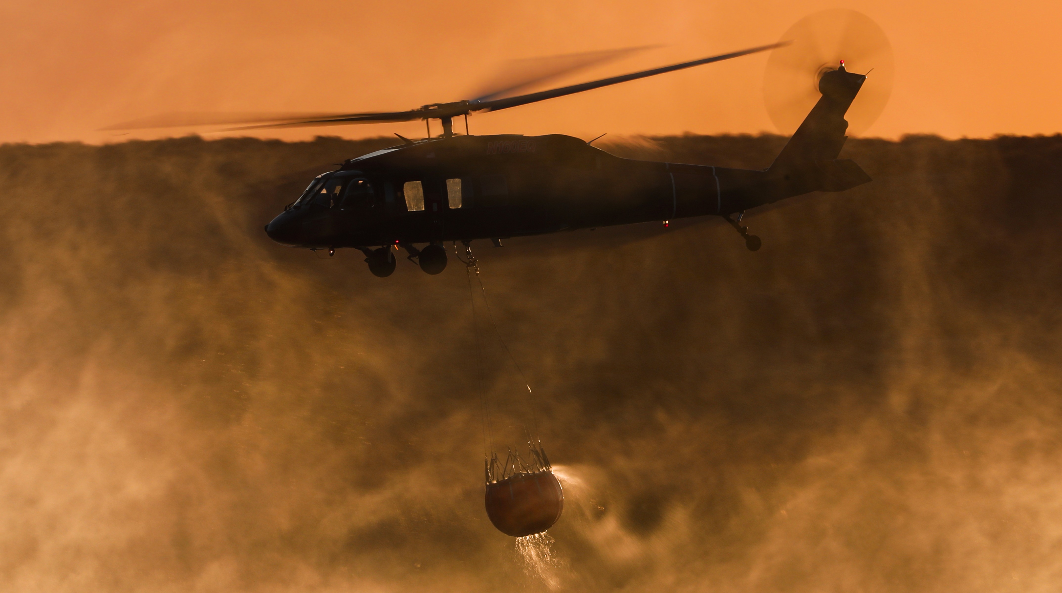 Copter 139 operating as a private contractor assigned to San Diego County, departs the Otay Lakes dip during the Border 2 Fire in the Otay Mountains of San Diego County.