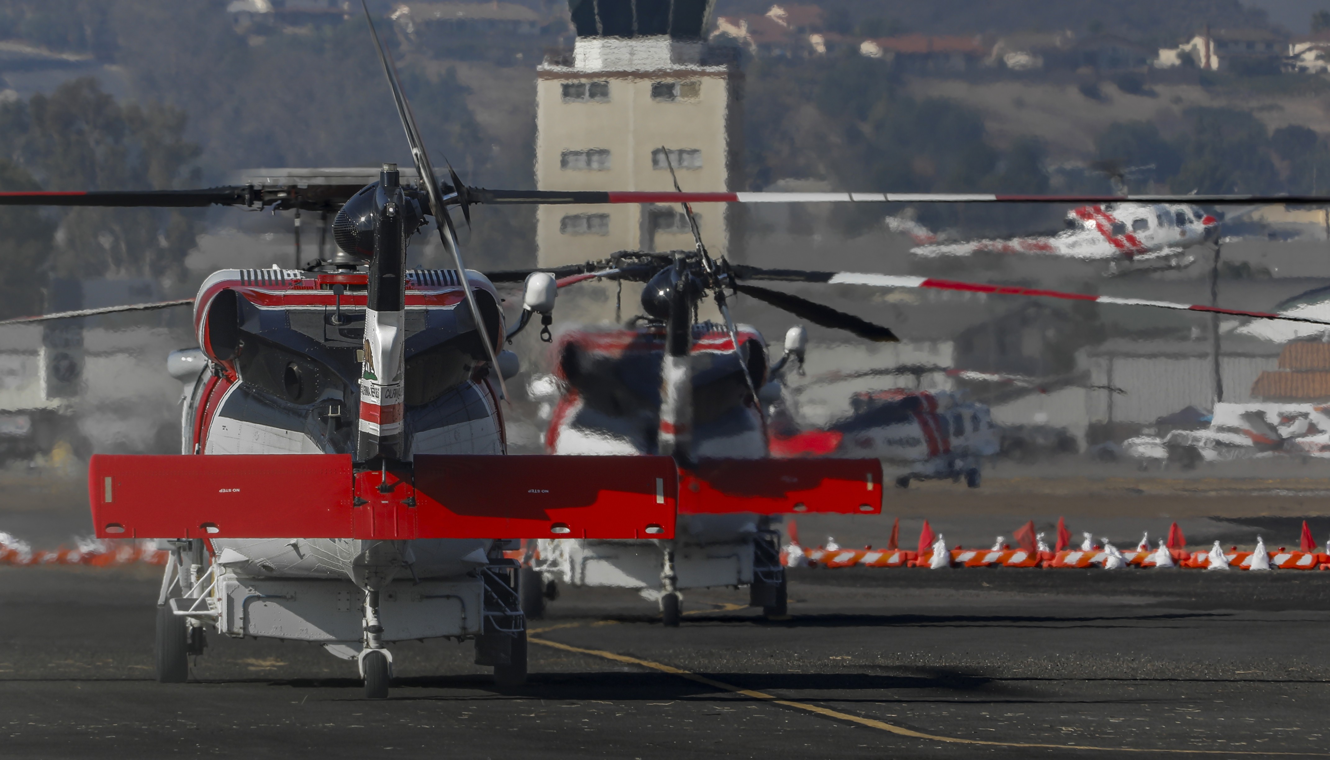 CAL FIRE Copters' 602, 605, 613, and 914 filling up the temporary helibase at the Gillespie airport in El Cajon, CA during large Border 2 Fire in the Otay Mountains.