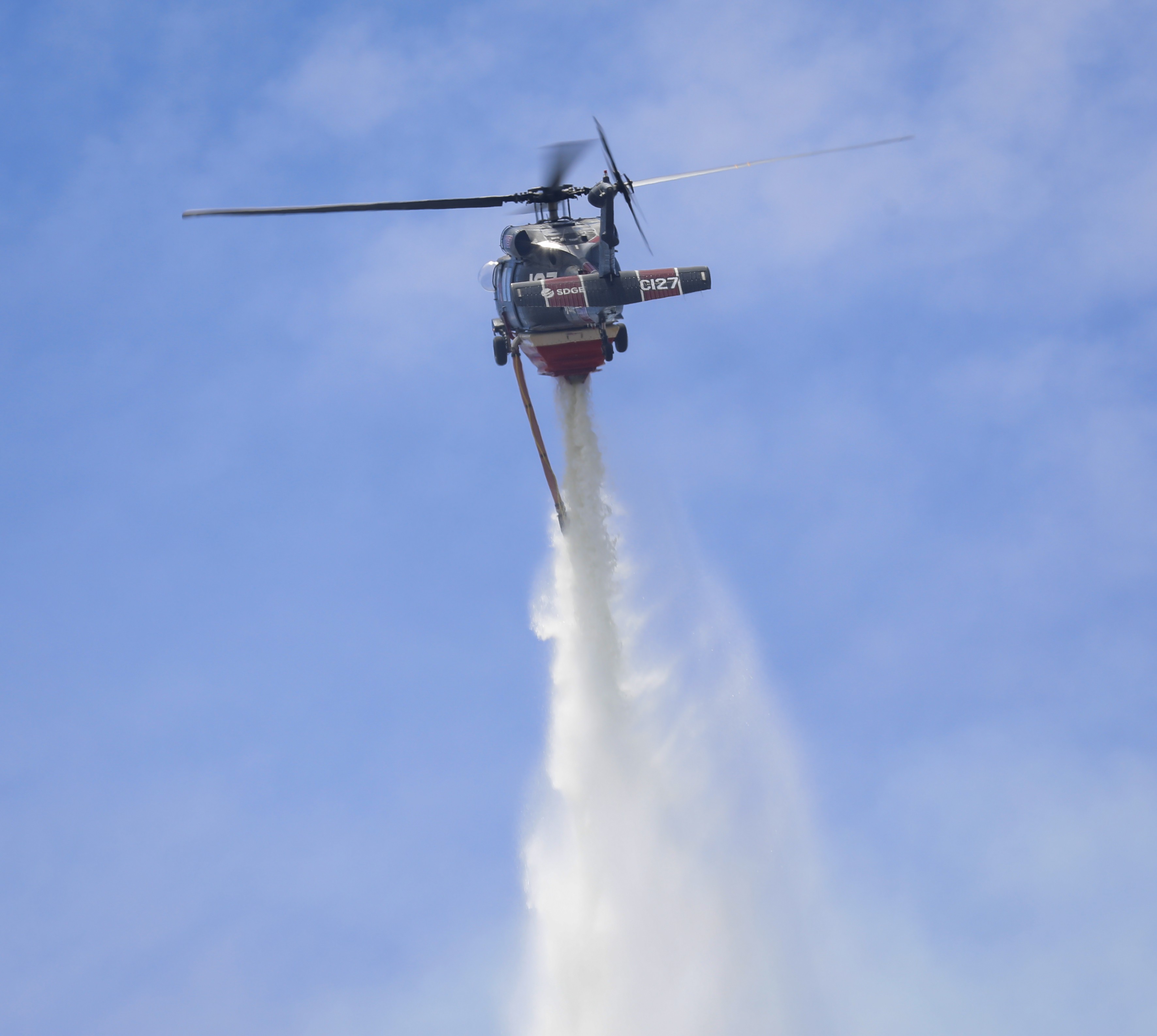 Copter 127 operating as a private contractor assigned to San Diego County during the fire season, dropping water during the Posta Fire in Campo, CA in July 2025.
