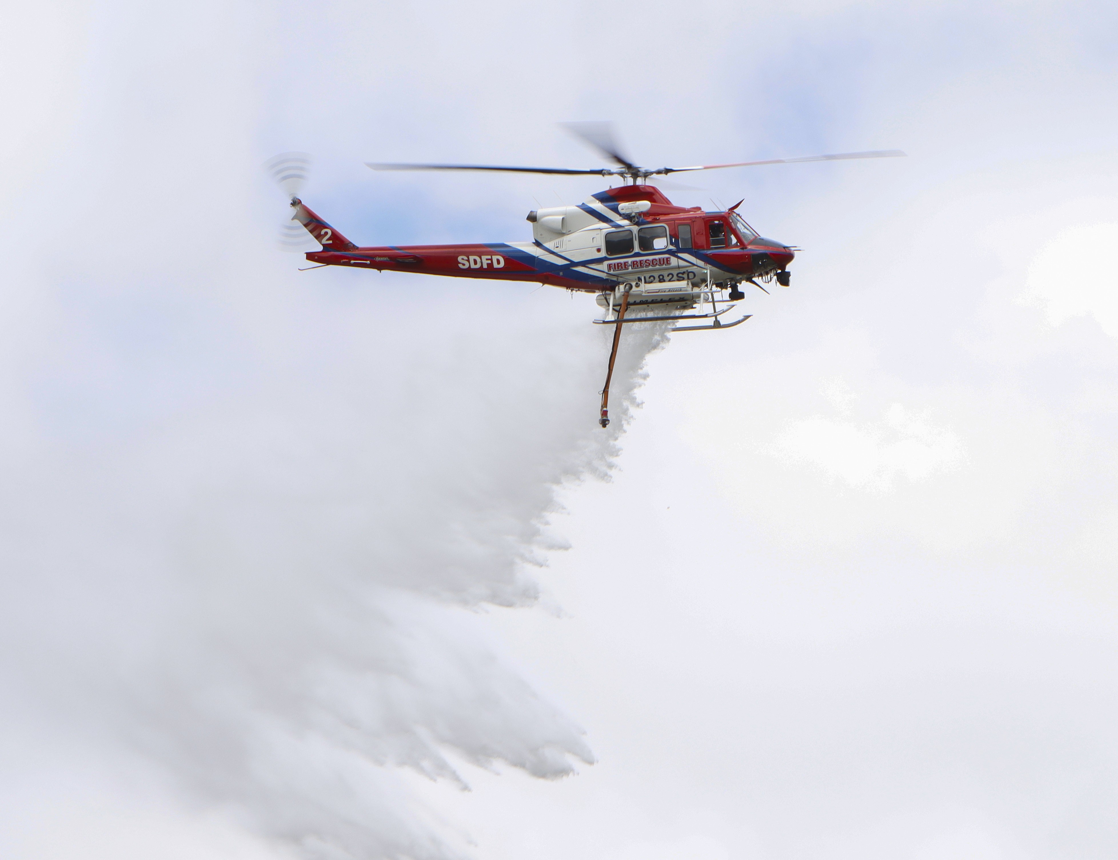 Copter 2 from the San Diego Fire-Rescue Air Operations Division, conducts water drops in the urban interface during a multi-agency training exercise in San Marcos, CA.