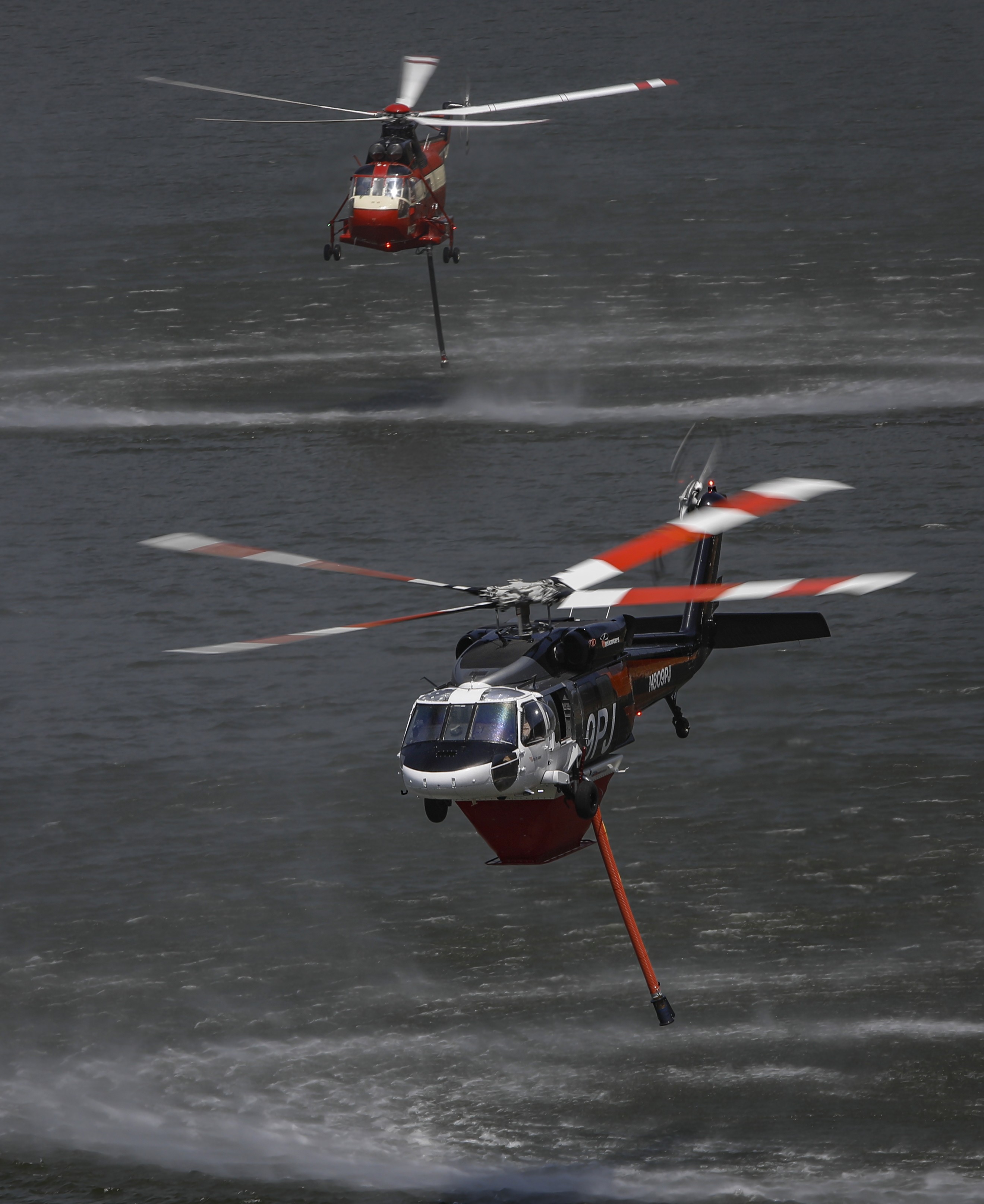 PJ Helicopters Copter 9PJ , shadowed by Siller Helitanker 917, feeling full after filling up with water at the El Capitan reservoir before returning to and resuming water drops on the Monte Fire.