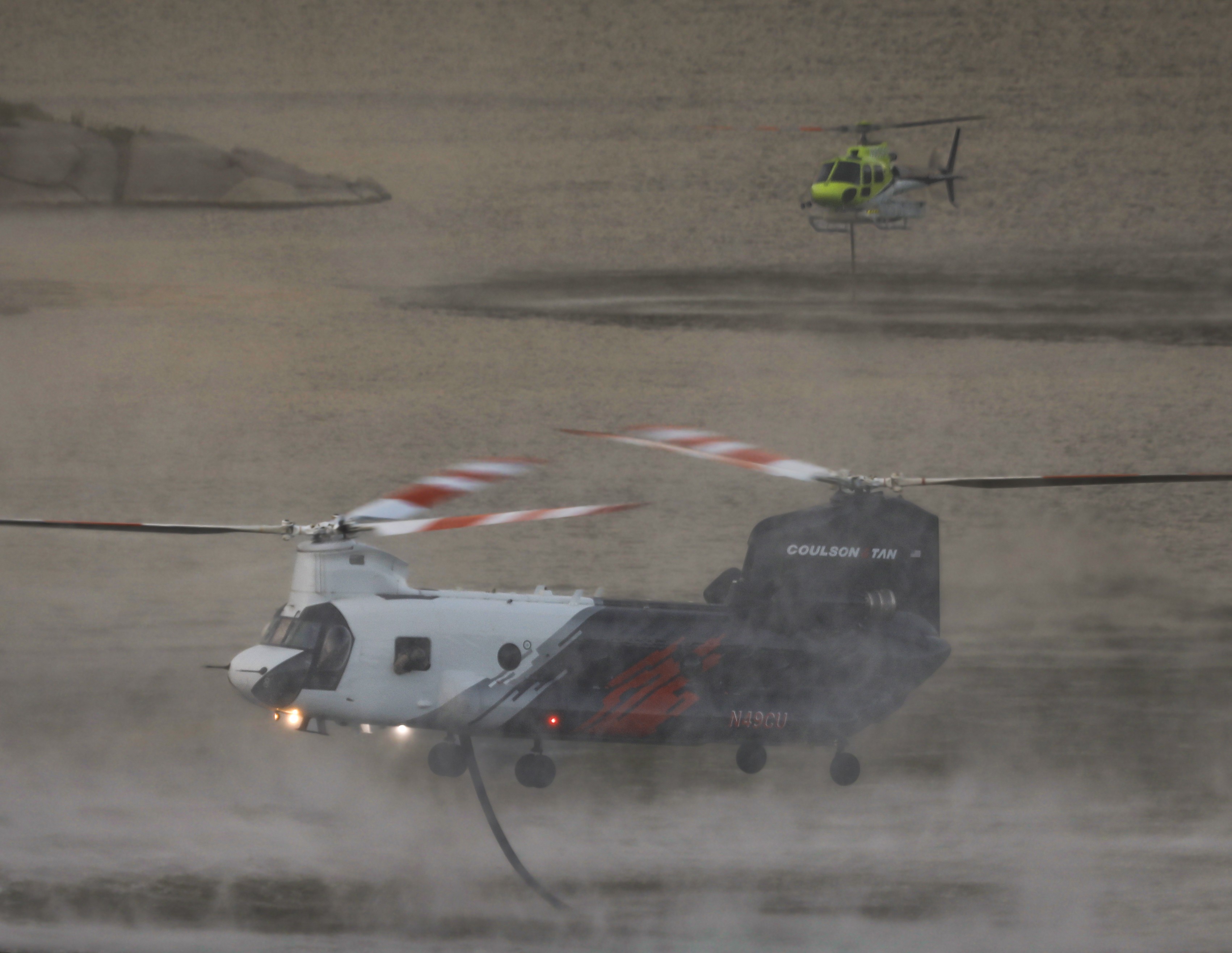 Coulson Aviation 49CU and USFS Keenwild Helitack 535, filling up with water at the El Capitan reservoir before resuming water drops on the Monte Fire.