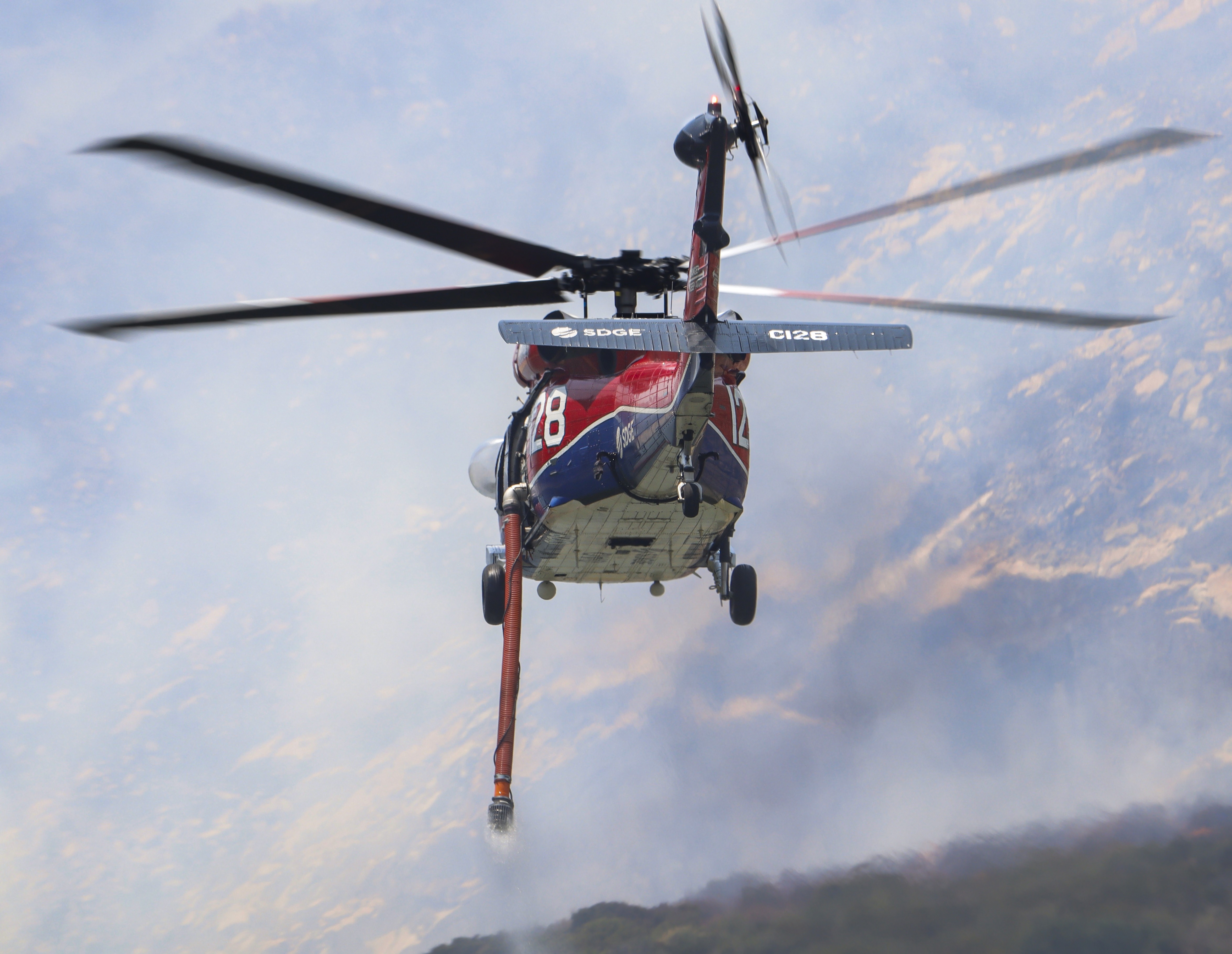 Copter 128 departs the El Capitan dip while supporting other firefighting agencies on containing a large vegetation fire in Lakeside, CA dubbed the Monte Fire.