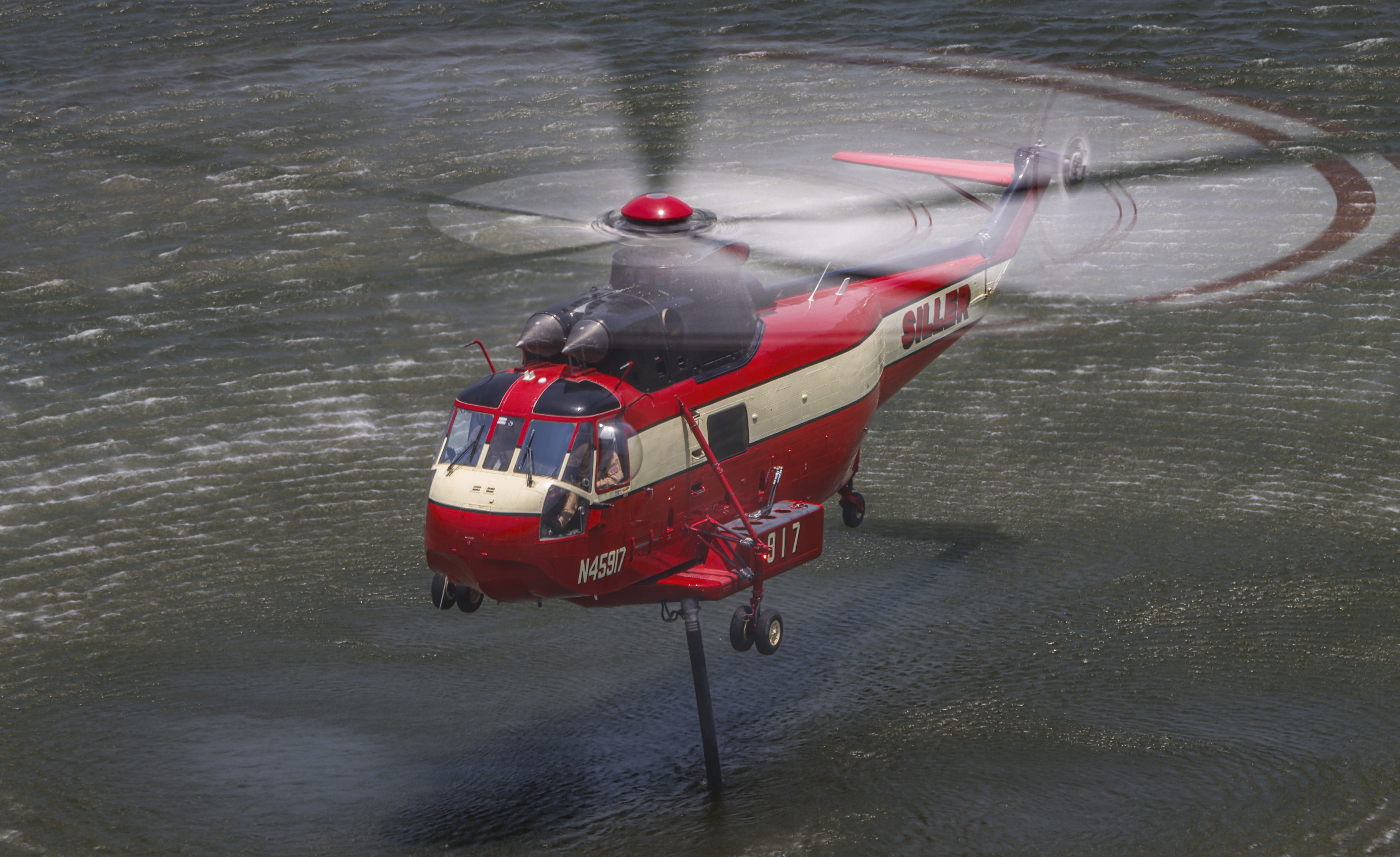 Siller Helicopters Helitanker 917, filling up on water while supporting other firefighting agencies on containing a large vegetation fire in Lakeside, CA dubbed the Monte Fire.