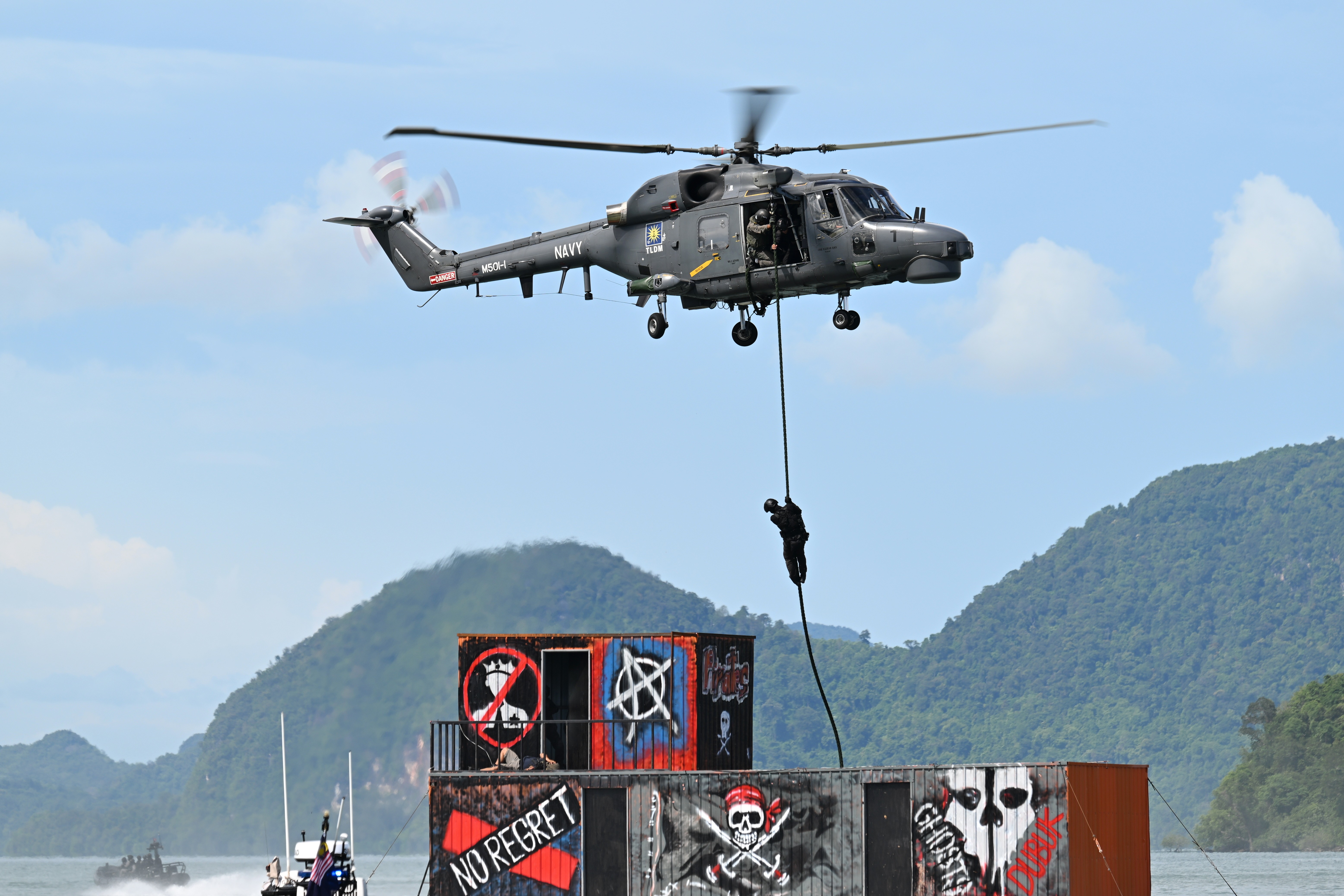 This WG13 Linx  M501-1 of TLDM (Malaysian Navy) is demostrating a Fast Rope drop during the counter terrorist display at Langkawi Resort World during LIMA 2025 Aerospace Exhibition