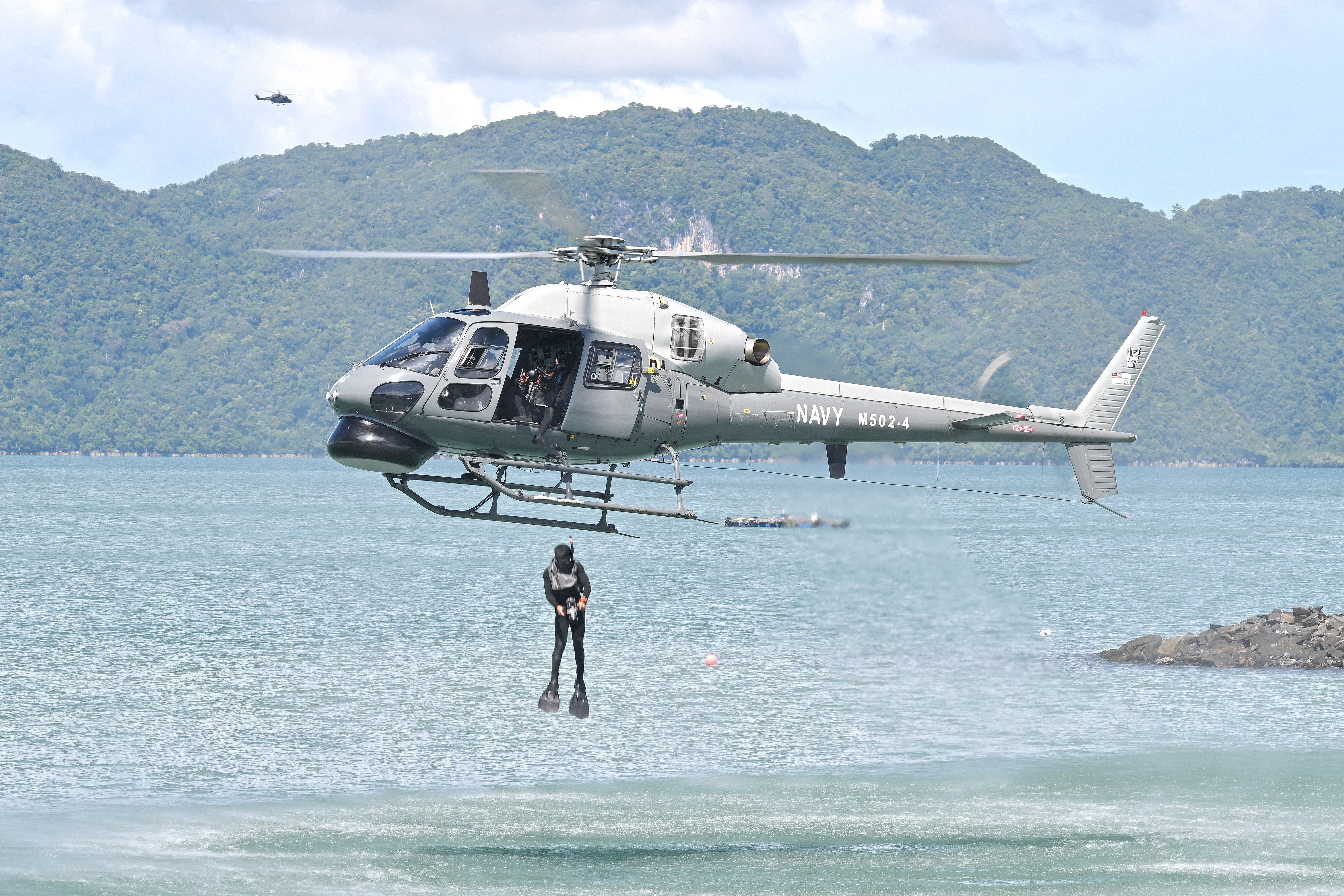 This As355N  M502-4 of TLDM (Malaysian Navy) is demostrating a scuba diving jump during the maritime display at Langkawi Resort World during LIMA 2025 Aerospace Exhibition